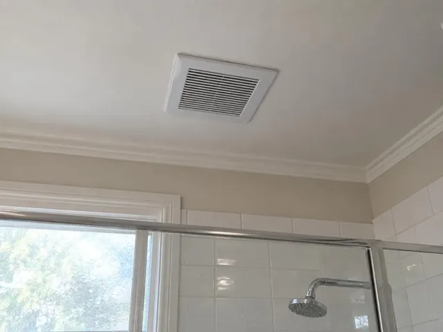 Ceiling exhaust fan above a tiled shower in a bathroom in Hornsby